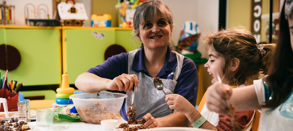 A girl and woman mixing something in a bowl
