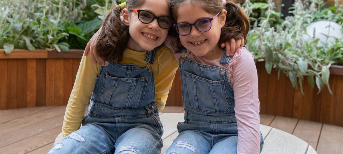 GOSH patients Iona and Beth in the sensory garden in the Sight and Sound Centre supported by Premier Inn