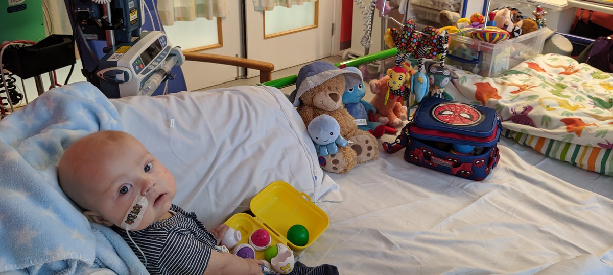 A little boy lying in a hospital bed