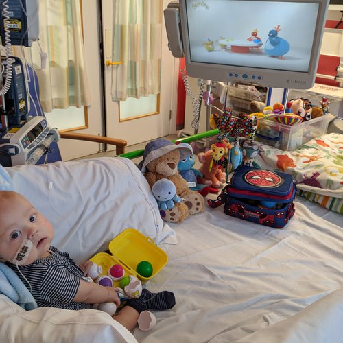 A little boy lying in a hospital bed