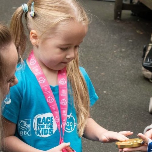 Amelia-Rose holds Beth's gold medal