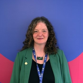 A woman standing in front of a painted office wall