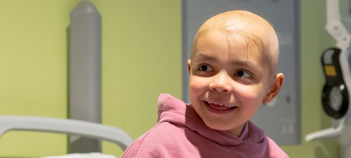 Photo of Arianna at GOSH, smiling and looking to the side.