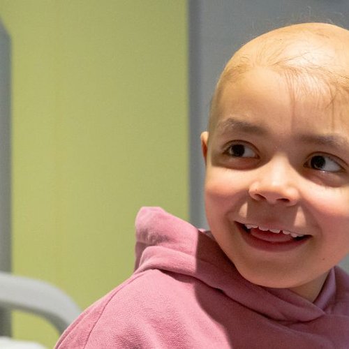 Photo of Arianna at GOSH, smiling and looking to the side.