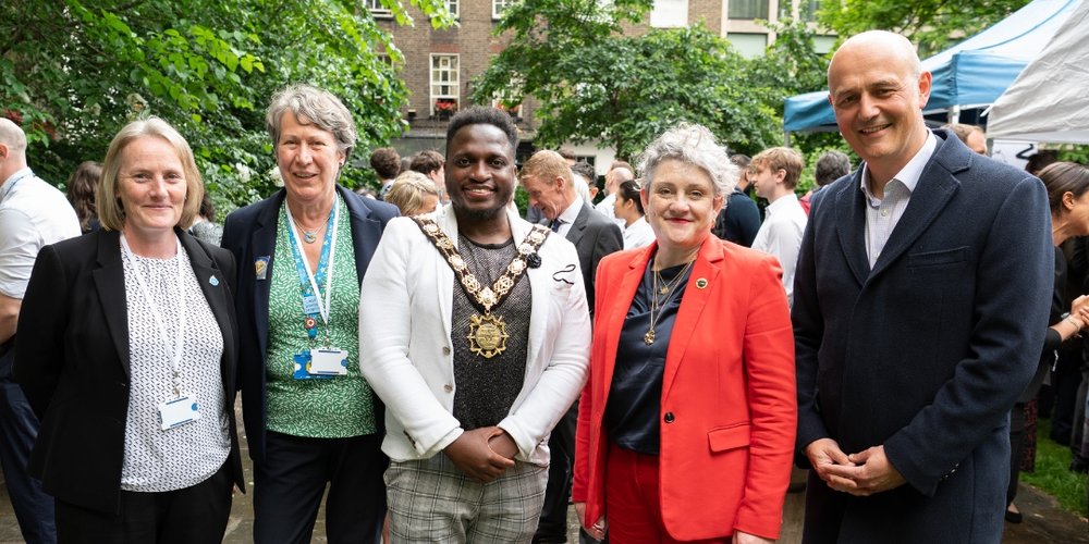 Members of staff, mayor of Camden and minister stand outside smiling to camera while attending GOSH's breaking ground event