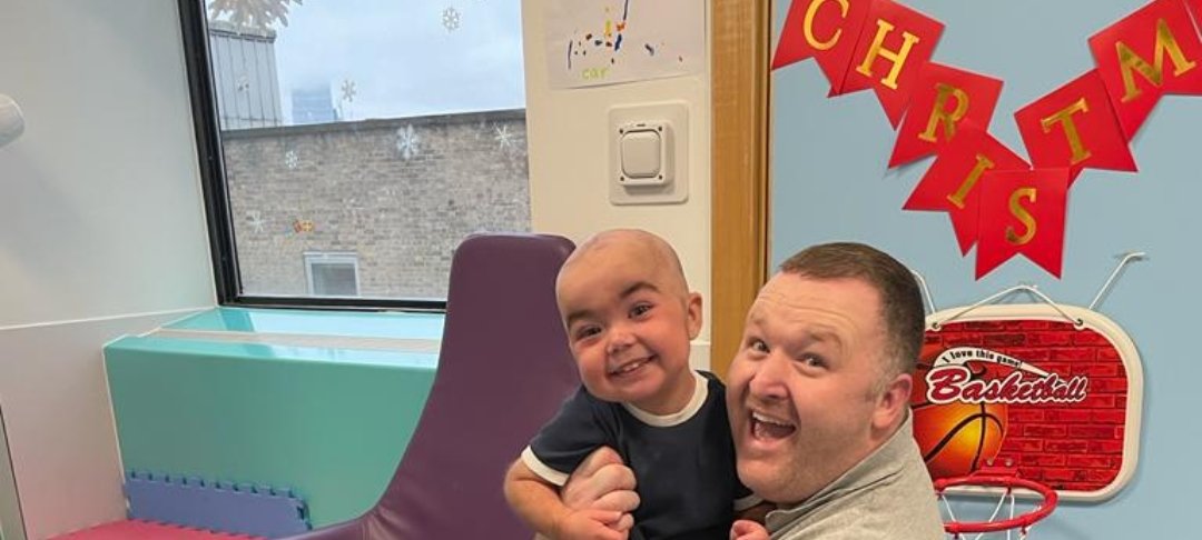 Daniel pictured with his dad at GOSH. Christmas decorations can be seen in the background.