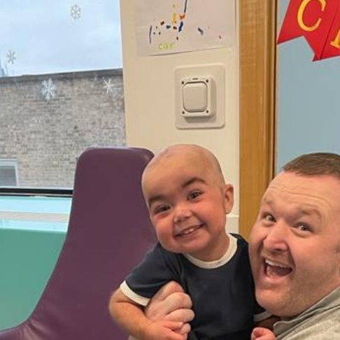 Daniel pictured with his dad at GOSH. Christmas decorations can be seen in the background.