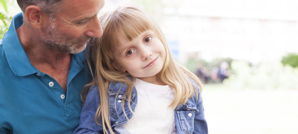 A little girl smiling with her dad