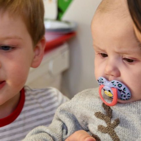 Baby Emmie at GOSH during Christmas, with her brother and mum.