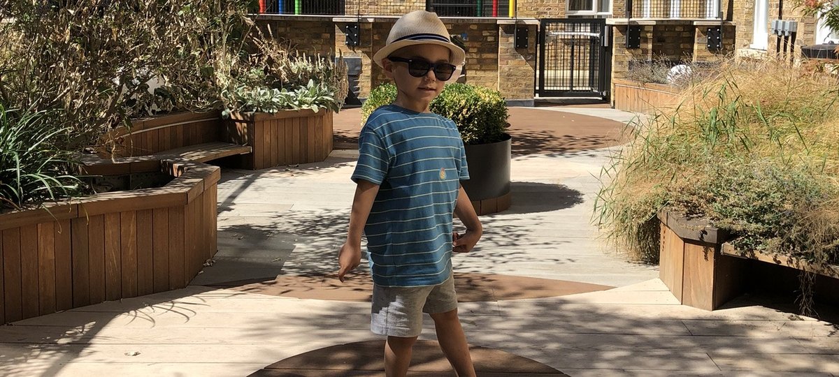 Joshua wearing sunglasses, in the garden at the Sight and Sound Centre