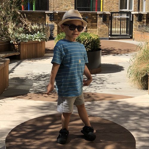 Joshua wearing sunglasses, in the garden at the Sight and Sound Centre