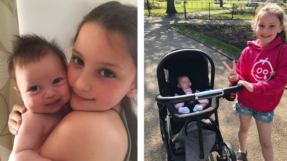 A little girl holding a baby