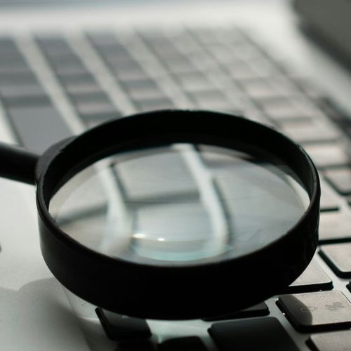 magnifying glass and laptop