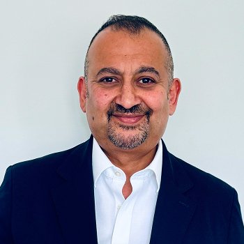 Headshot of trustee Masood smiling
