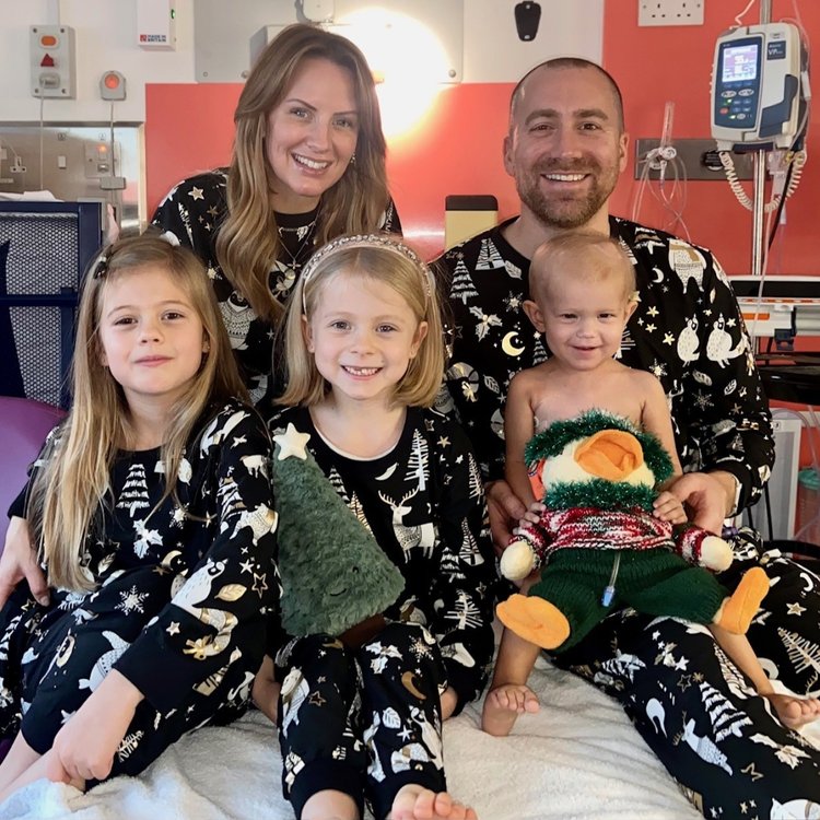 Orla with her mum, dad and sisters, wearing matching Christmas outfits