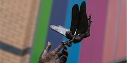 Tinkerbell holding Peter Pan's hand sculpture