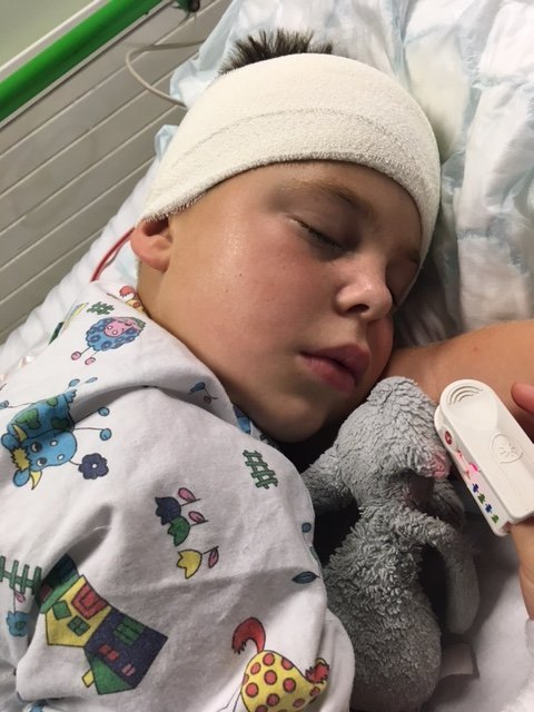 A boy recovering from a brain operation