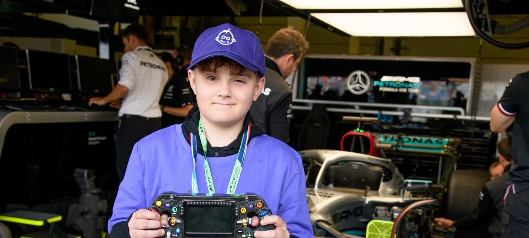 Josh at F1 event wearing GOSH Charity hat and t-shirt