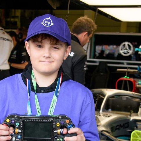 Josh at F1 event wearing GOSH Charity hat and t-shirt