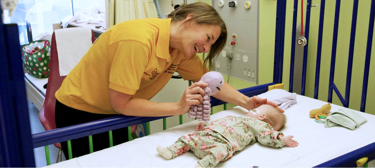 Volunteer with GOSH patient in cot