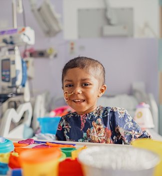 A little girl sitting on a hospital bed