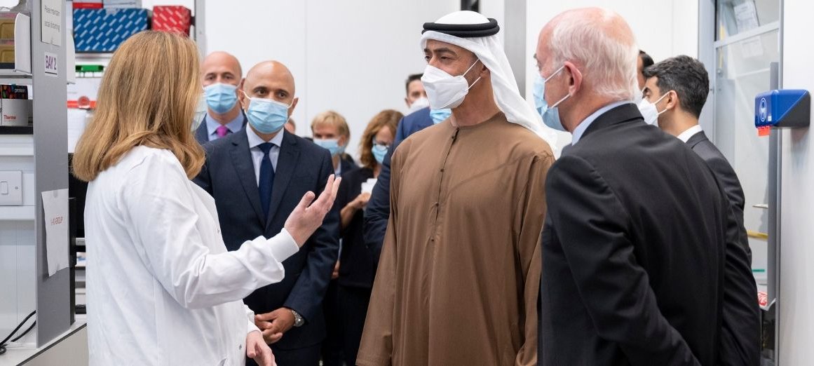 Dr Claire Booth presents to His Highness Mohamed Bin Zayed in lab