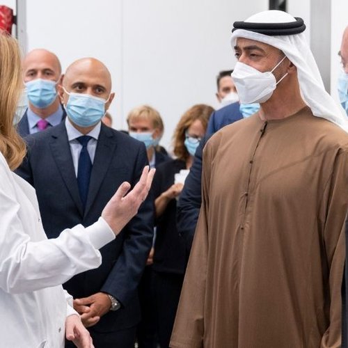 Dr Claire Booth presents to His Highness Mohamed Bin Zayed in lab