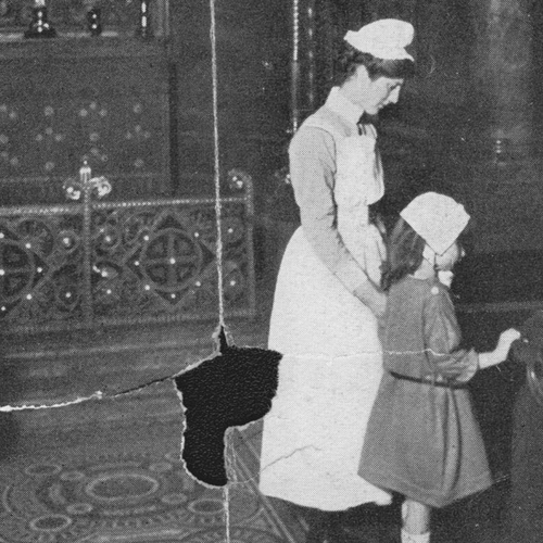 Black and white image showing two girls wearing bonnets inside the chapel. A nurse in floor length uniform stands with them. The image has been torn due to being old.