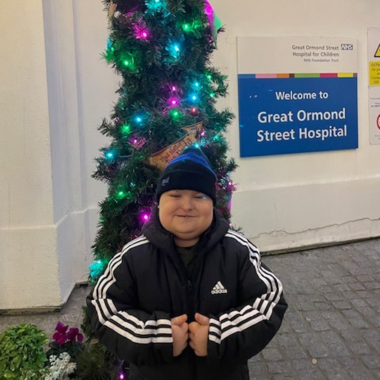 Rowan infront of the GOSH Christmas Tree