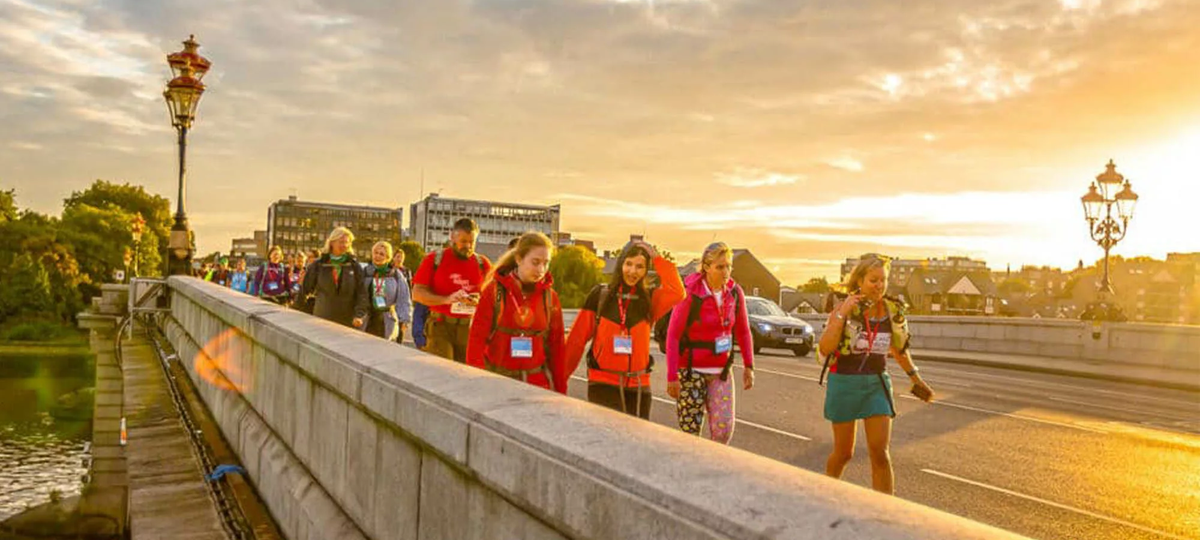 Participants at the Thames Bridges, walking across the bridge at sunset