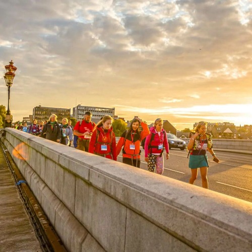 Participants at the Thames Bridges, walking across the bridge at sunset